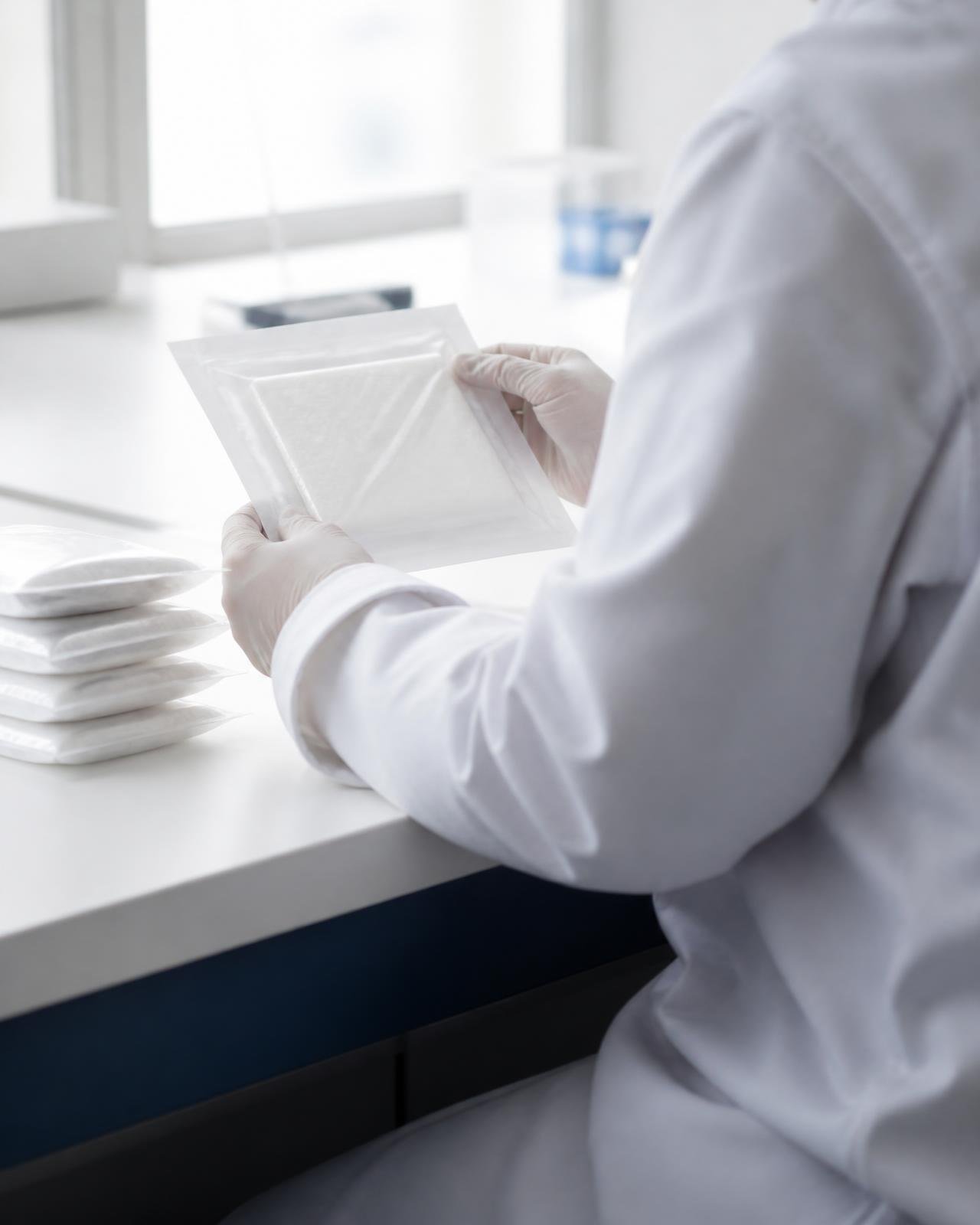 Technician inspecting sterile medical dressing packs